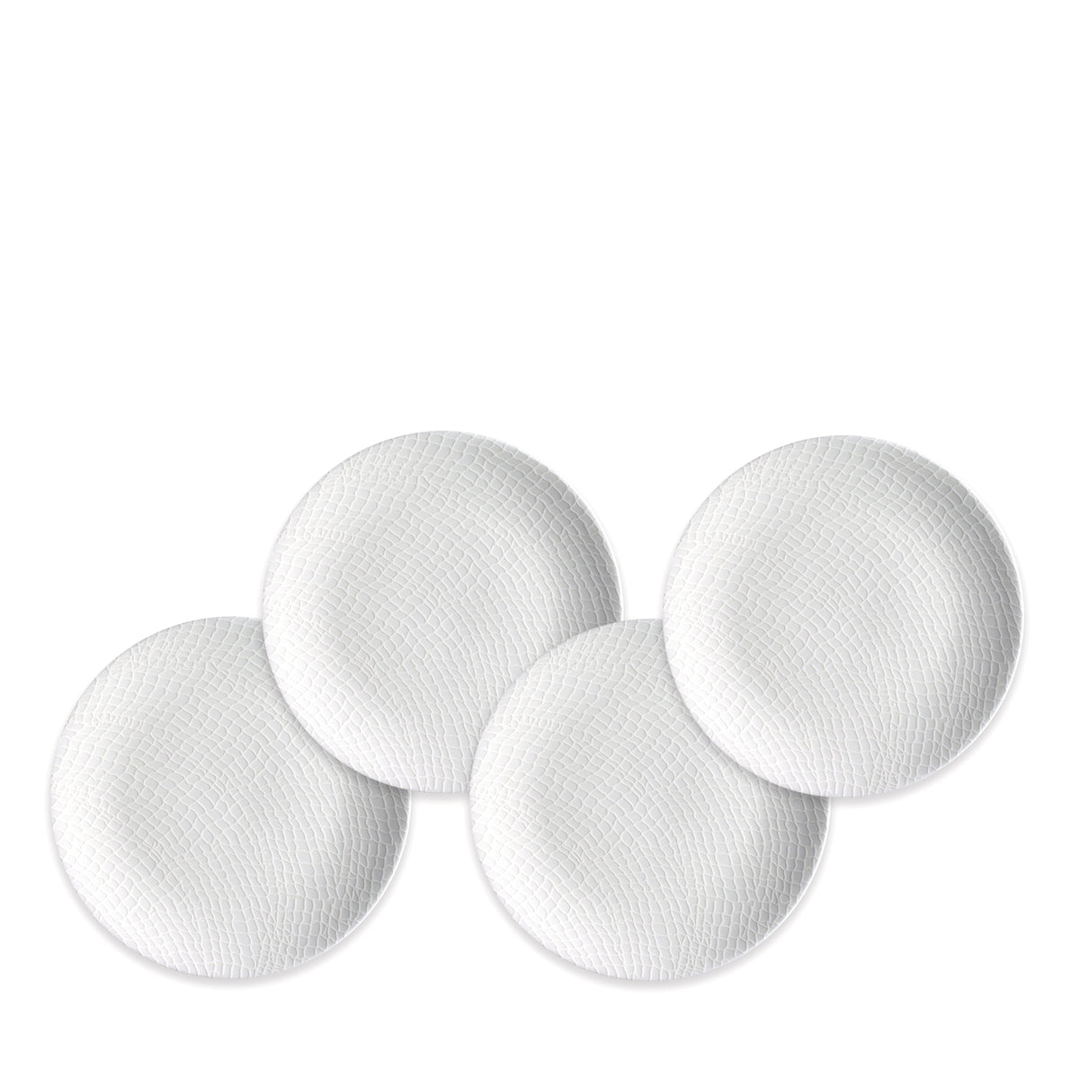 Four round, textured, white Catch Small Plates from Caskata Artisanal Home are arranged in a slightly overlapping pattern against a plain background, reminiscent of small plates caught in a fisherman&#39;s net.