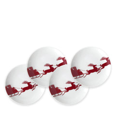 This set of four heirloom-quality Sleigh Small Plates from Caskata Artisanal Home showcases a red design of Santa in a sleigh pulled by reindeer, artfully arranged in an overlapping pattern.
