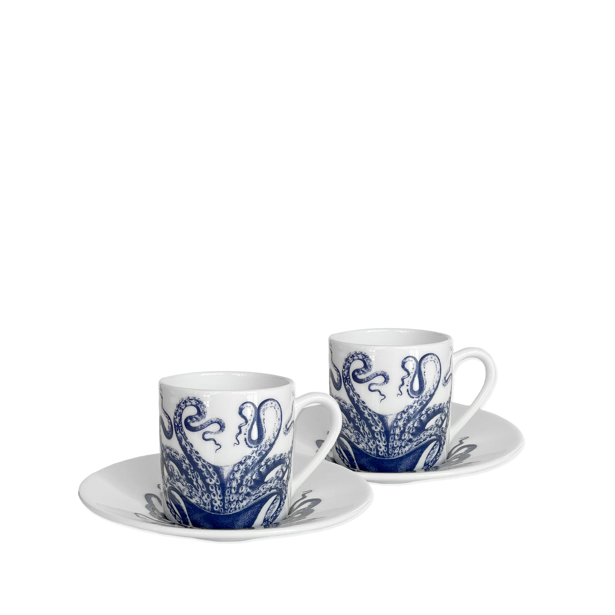 Two white bone china Lucy espresso cups &amp; saucers, set of 2 by Caskata, with blue octopus designs, each placed on matching saucers.