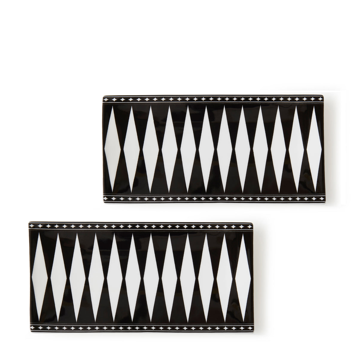 Two rectangular bone china plates feature black and white geometric diamond patterns with star accents along the borders, evoking an Art Deco elegance reminiscent of Caskata&#39;s Marrakech Medium Sushi Trays, Set of 2.