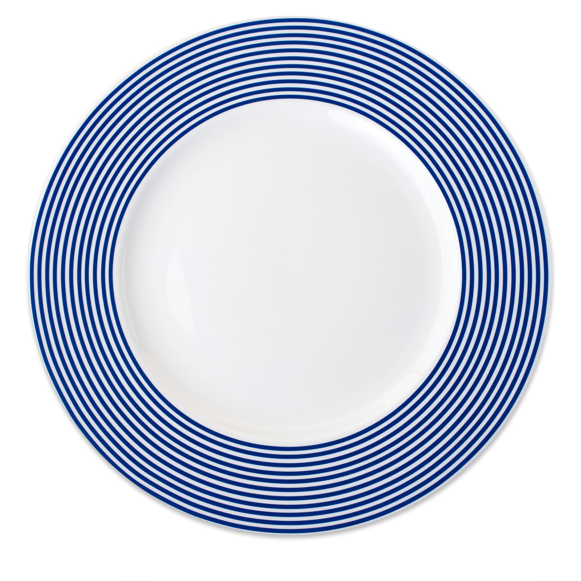 White ceramic Newport Rimmed Charger Plate by Caskata Artisanal Home, featuring concentric Newport Stripe blue circles.