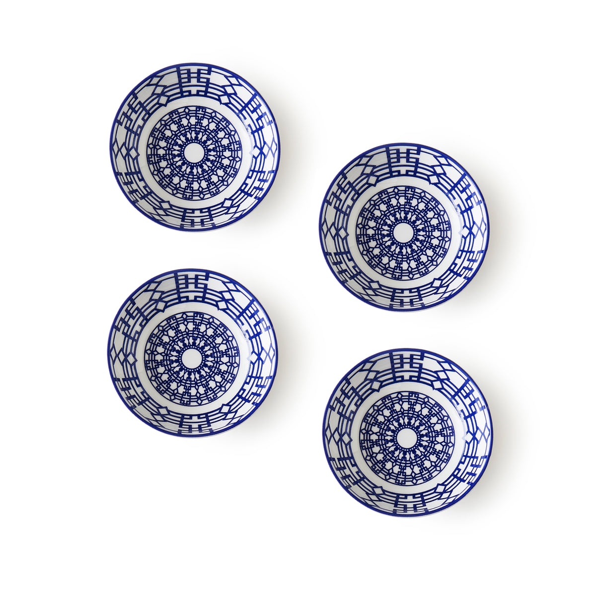 Four Newport Dipping Dishes, Set of 4 by Caskata with intricate blue geometric patterns, reminiscent of the Newport Garden Gate&#39;s interlocking lattice pattern, are evenly spaced against a plain white background.