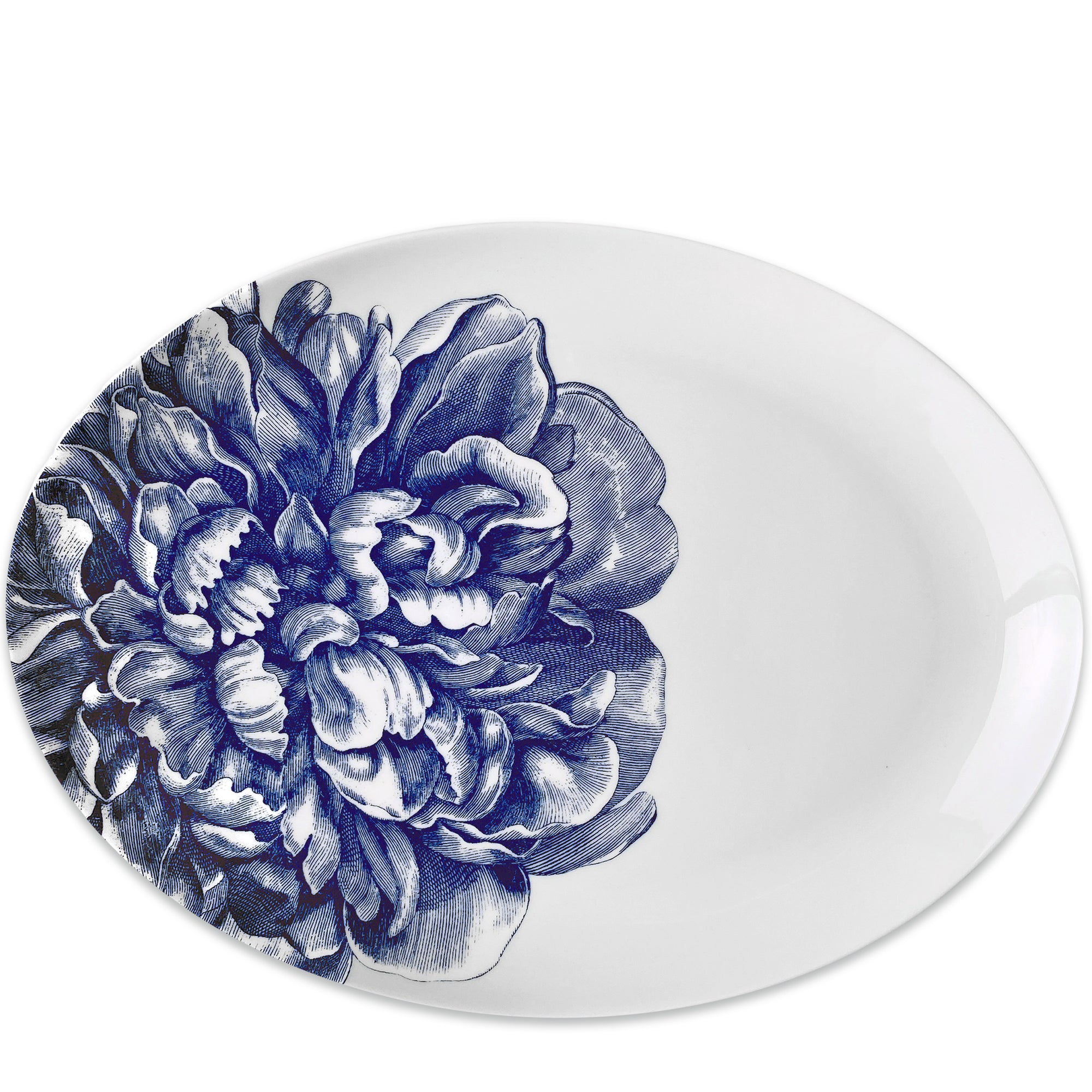 White oval porcelain Peony Medium Coupe Oval Platter with a detailed blue floral dinnerware pattern on one side by Caskata Artisanal Home.