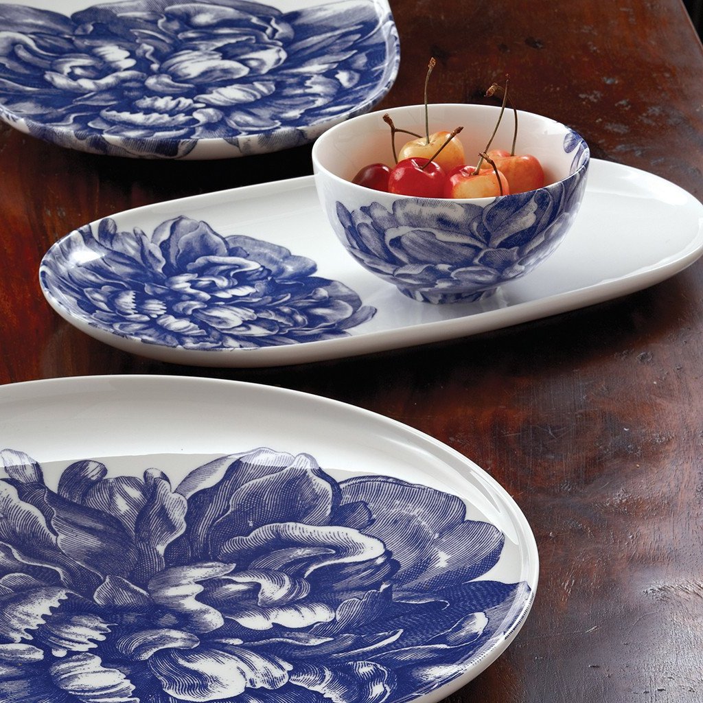 Three Peony Snack Bowls from Caskata Artisanal Home on a wooden table, one containing cherries.