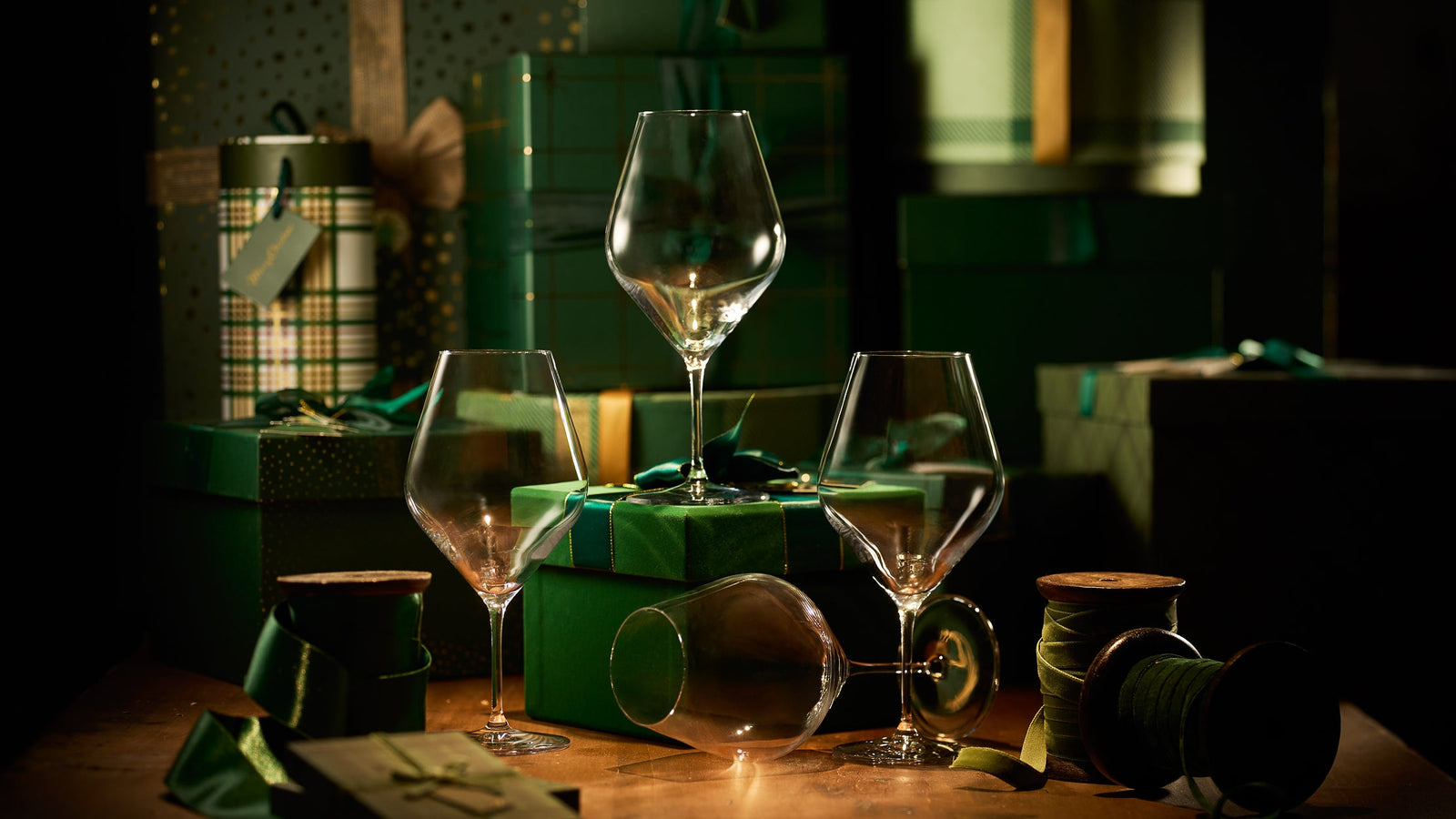 Elegant simply Caskata glassware collection surrounded by gift wrap