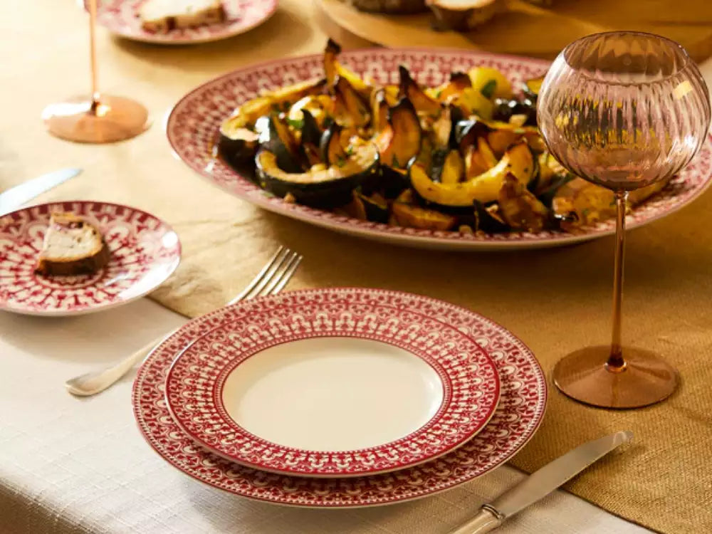Elegant porcelain dinnerware table setting with blue and white Caskata plates
