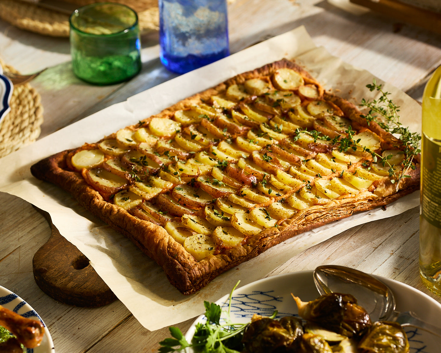 Potato Tart with Goat Cheese and Thyme on a Dinner Table