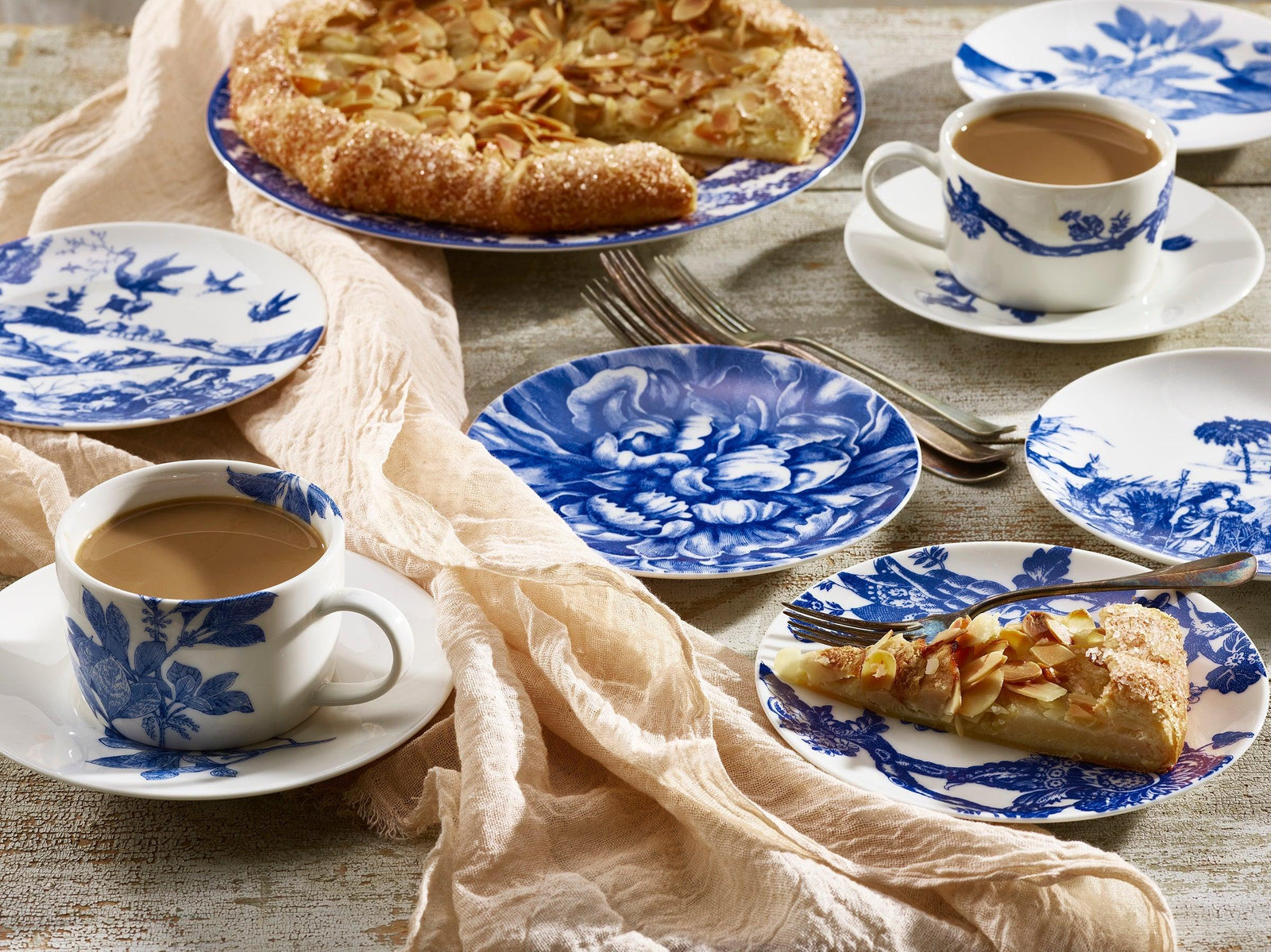 A table with plates of food and coffee.