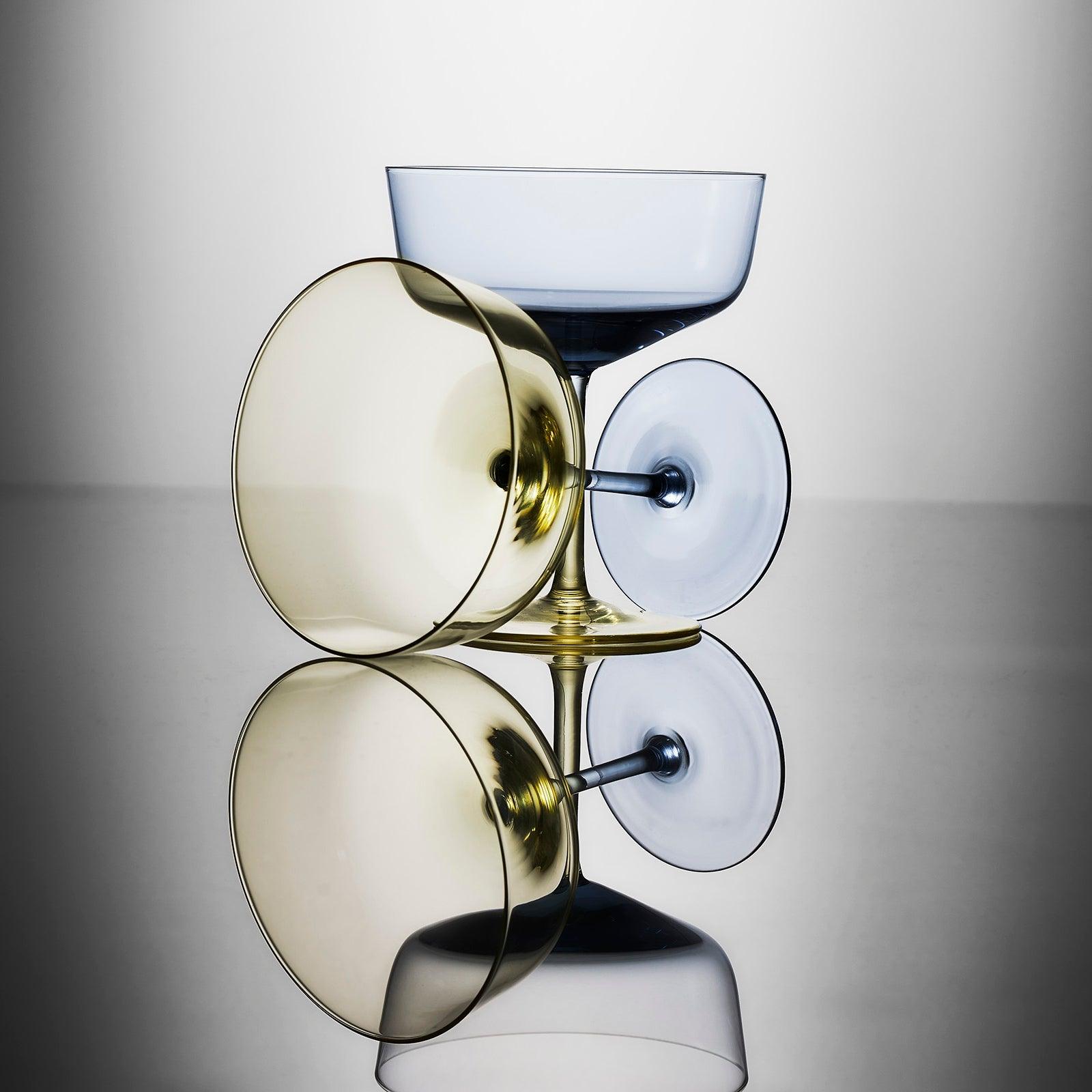 A pair of glasses with a reflection on a surface.