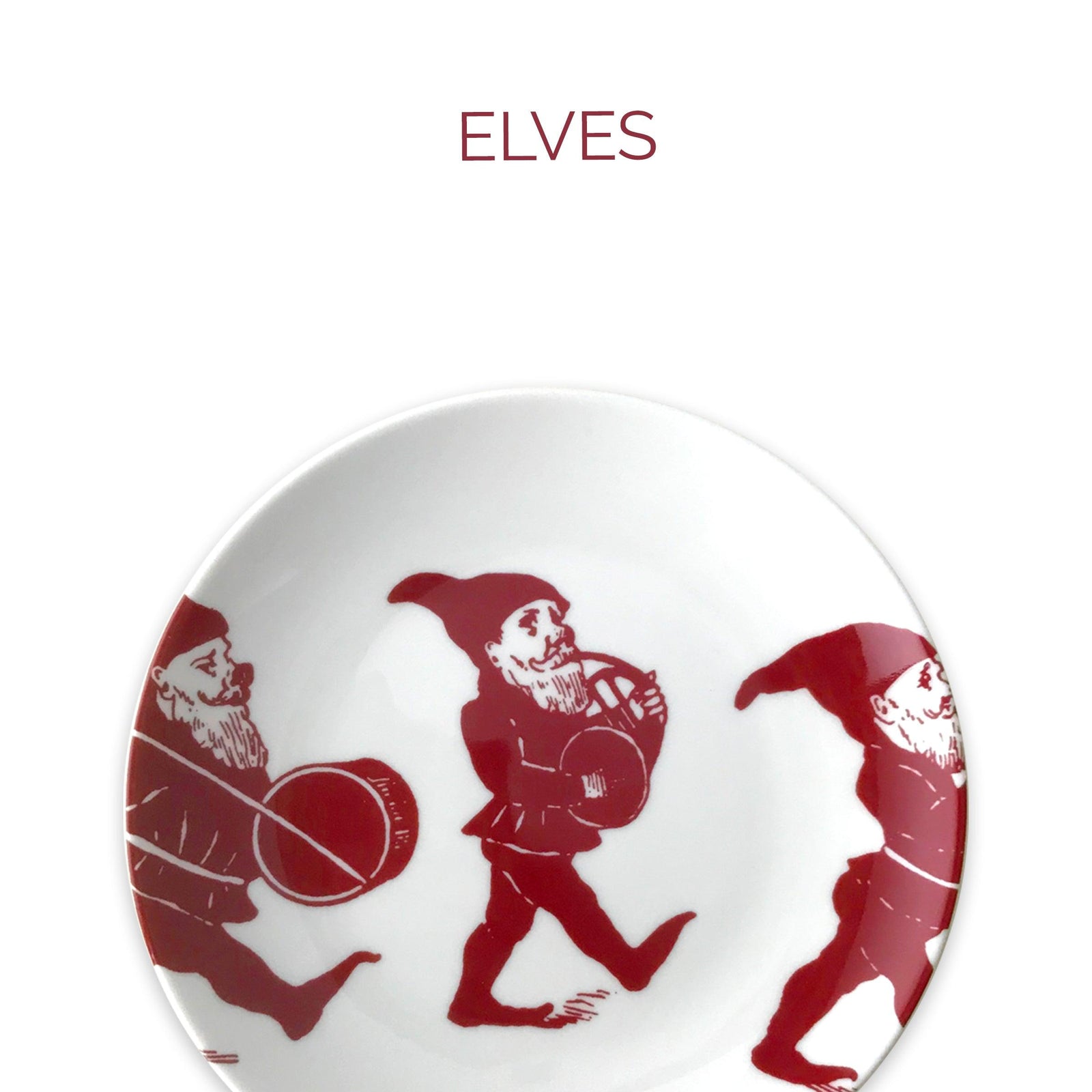 A plate featuring a design of three elves marching with musical instruments, depicted in red against a white background. The word "ELVES" is written above the plate.