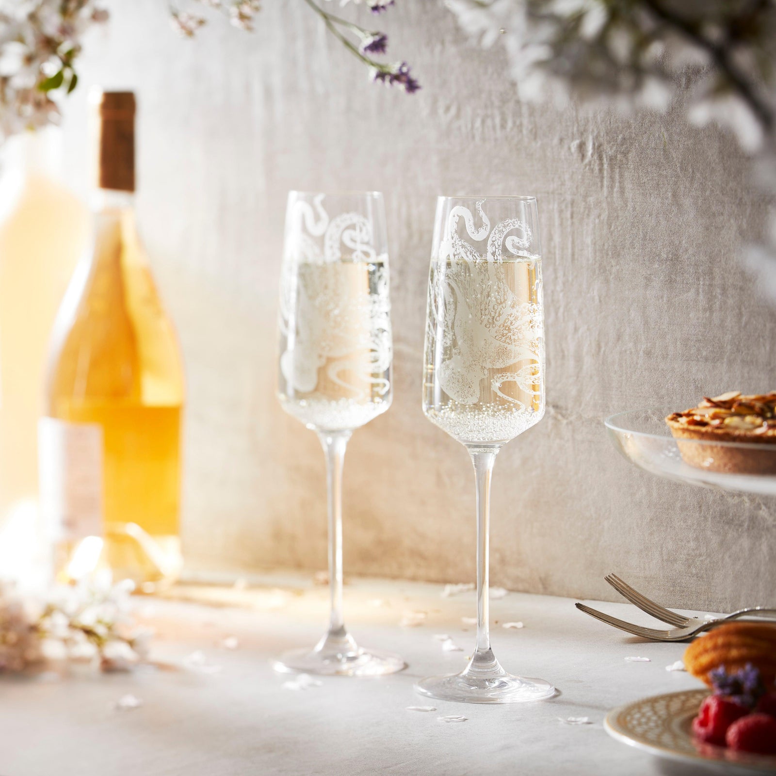 Lucy the Octopus Champagne Flutes in etched crystal from Caskata in a wedding scene
