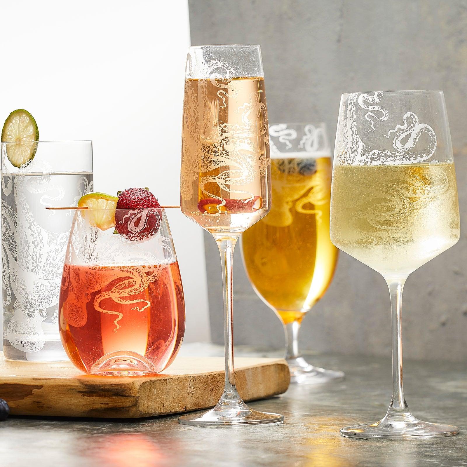 A group of glasses of different colored drinks.