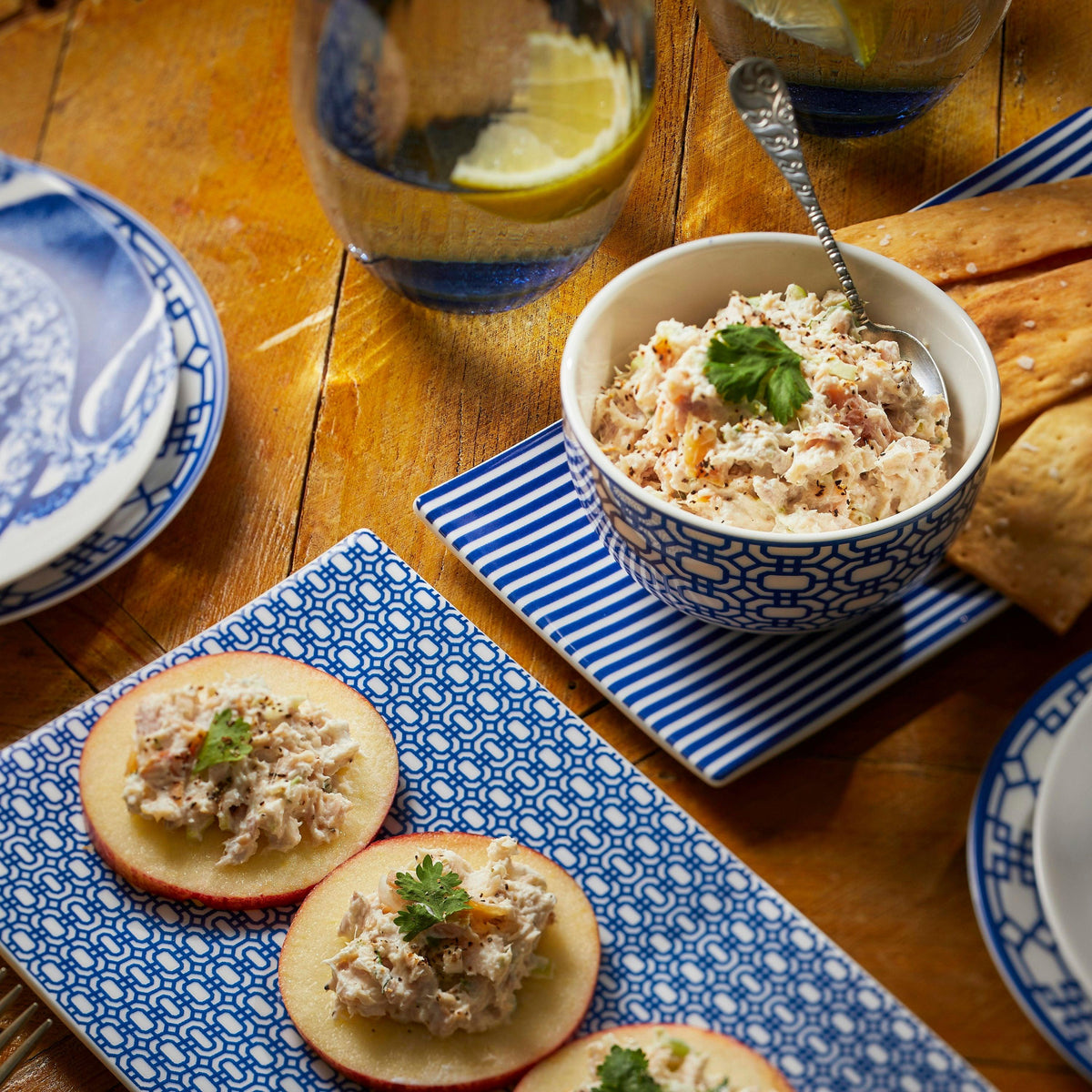 Blue and white Newport Snack Bowls with appetizers on them.