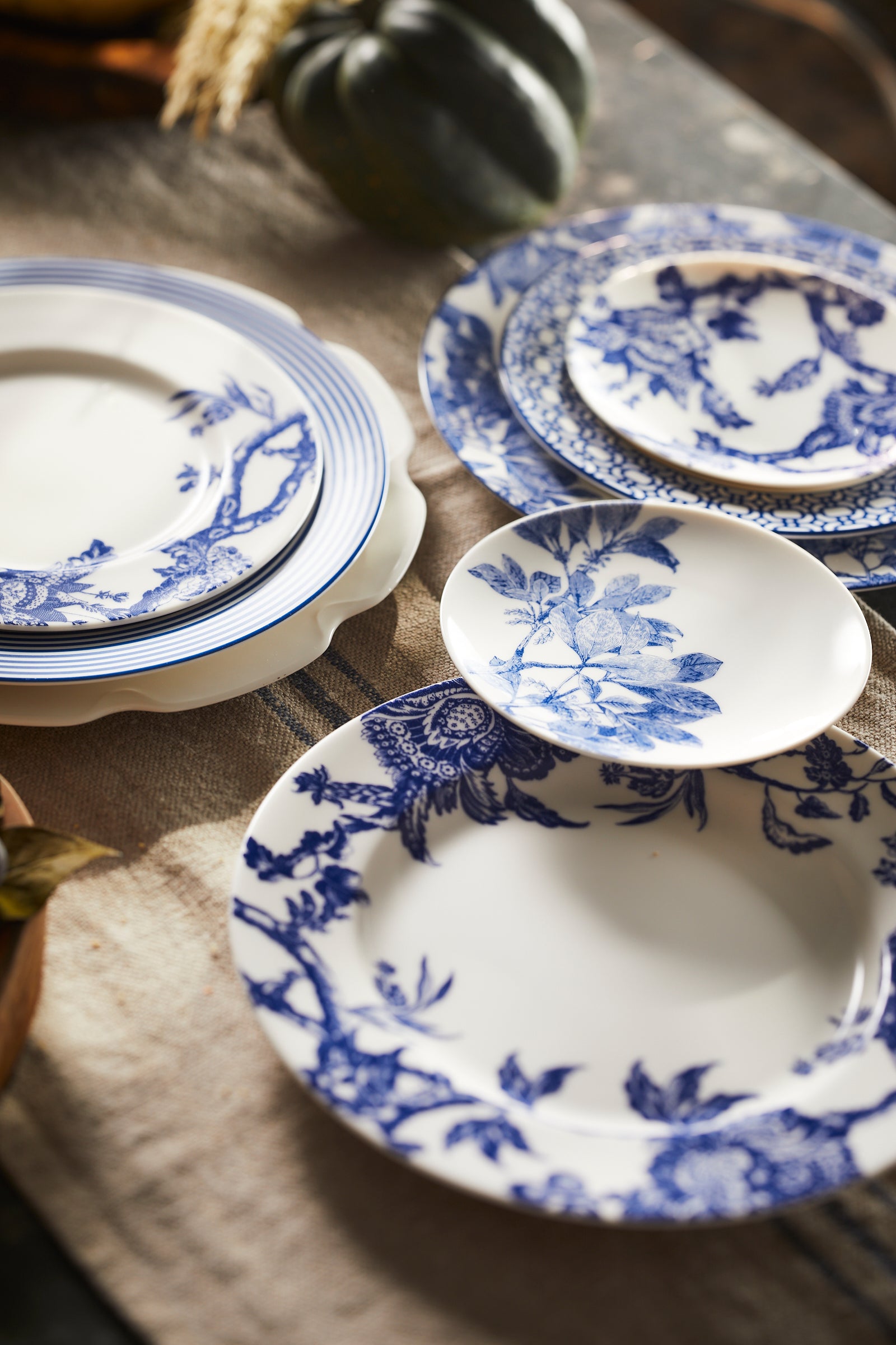 Blue and White Porcelain Collection from Caskata featuring Peony and Arbor patterns in high-fired dinnerware including dinner plates, salad plates, appetizer plates, mugs and serving platters and bowls.