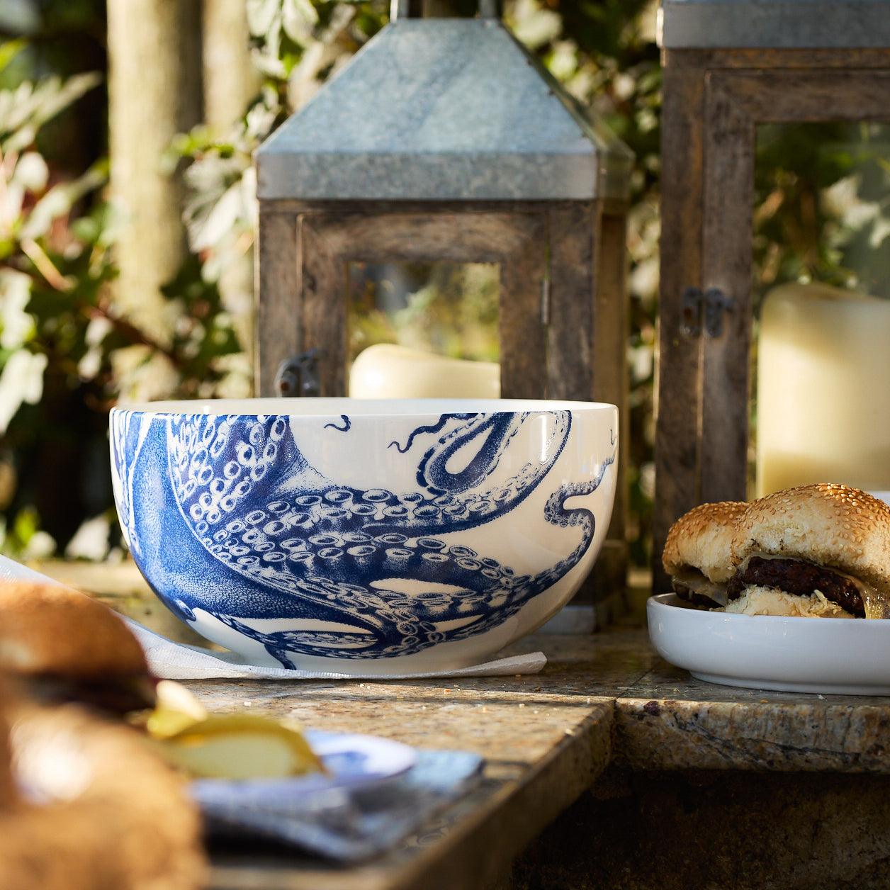 A blue and white porcelain Lucy Large Round Serving Bowl with an octopus signature motif from Caskata Artisanal Home.