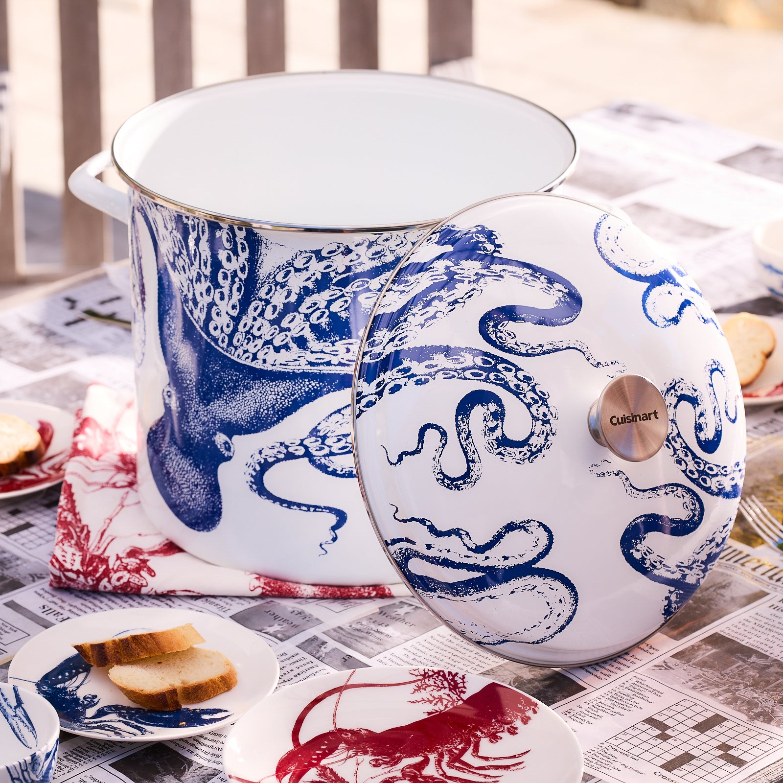The Caskata X Cuisinart Lucy 16 Qt. Enamel on Steel Stockpot, from the Cuisinart kitchen products line, features an enchanting blue octopus design on its white exterior. This functional stockpot includes handles and a lid, combining style with practicality.