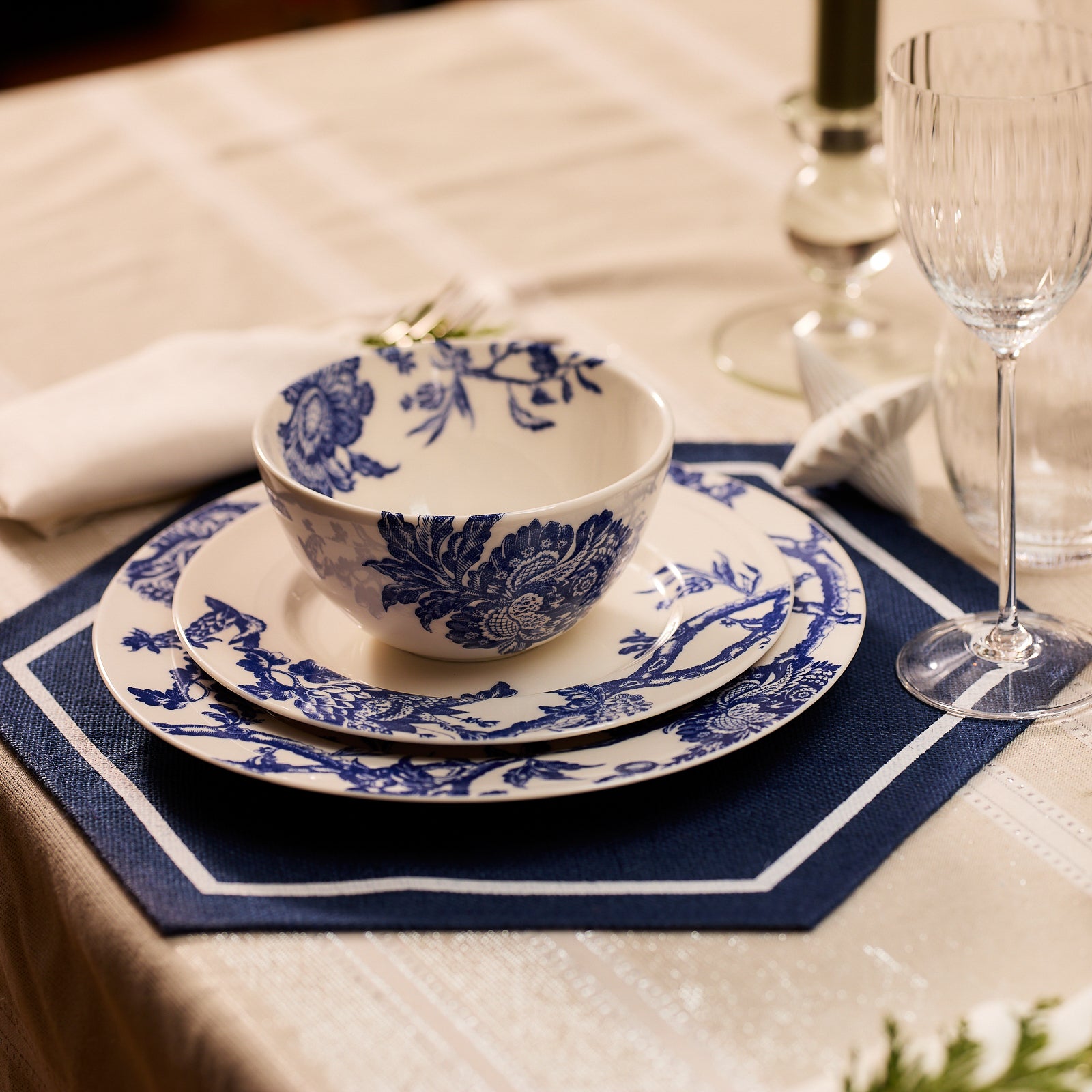 The Caskata Arcadia Table for 8 is a premium porcelain dinnerware set with white plates, side plates, and bowls adorned in blue floral patterns. Dishwasher and microwave safe—perfect for effortless everyday dining.