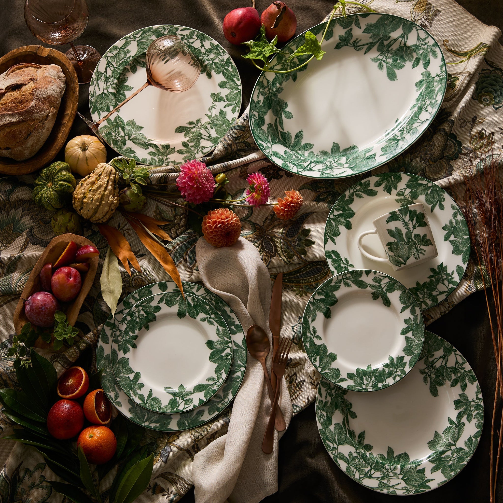 A table setting featuring Caskata's Arbor Green Rimmed Dinner Plate ...