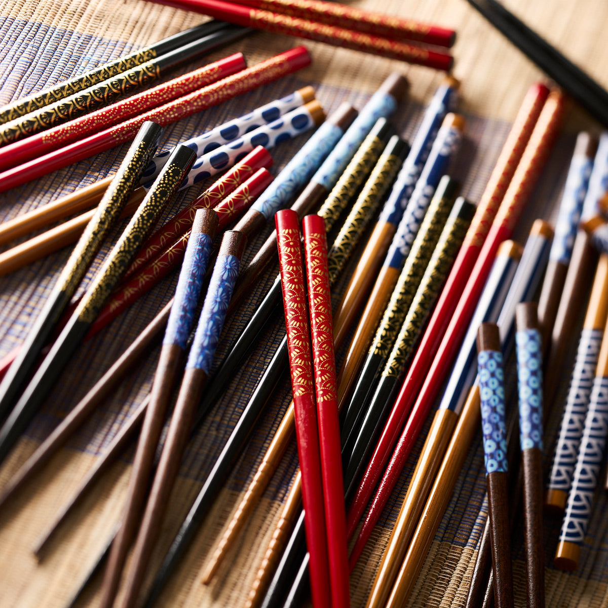 A group of Tokyo Chopsticks from Miya, Inc., with intricate gold patterns laying on a table.