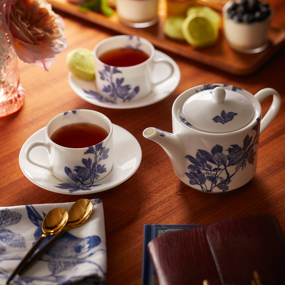 Two Blue Arbor Cups &amp; Saucers Set/2 by Caskata Artisanal Home on a table, each accompanied by a saucer.