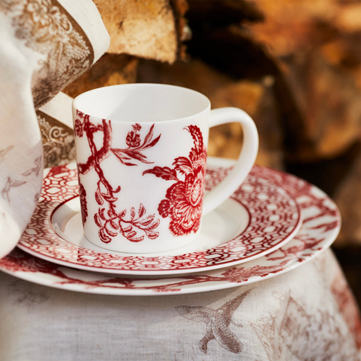 Arcadia Crimson Red and White Porcelain Mug from Caskata is seen here matched with a Crimson Newport Garden Gate salad plate and Arcadia Crimson dinner plate for an effortless and whimsical place setting. 