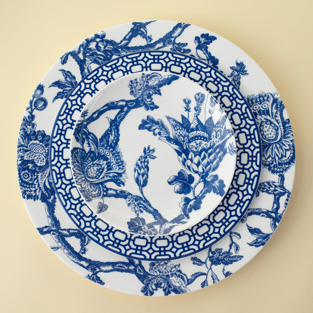 A Newport Garden Gate Salad Plate by Caskata Artisanal Home, featuring a contemporary blue and white color scheme and a floral pattern.
