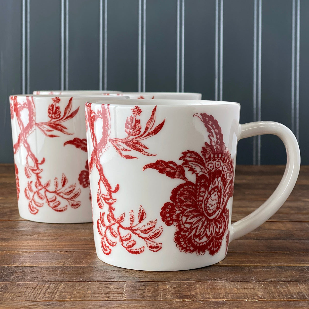 A closeup photo of the red and white Arcadia Crimson Mug from Caskata shows the detailed design pulled from the Williamsburg Collection archives.