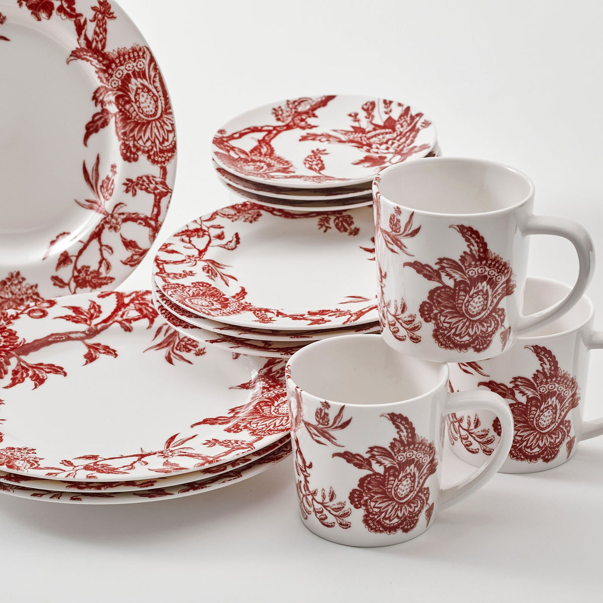 Close Up Showing mugs in the Arcadia Crimson 16 Piece dinnerware Set for 4 in high-fired porcelain from Caskata. Set includes 4 dinner plates, 4 salad plates, 4 canape plates, and 4 mugs.