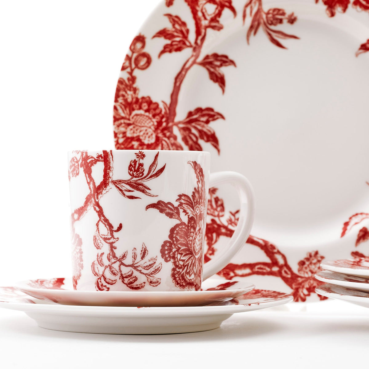 Close Shot of Mug and Dinner Plate in the Arcadia Crimson 16 Piece dinnerware Set for 4 in high-fired porcelain from Caskata. Set includes 4 dinner plates, 4 salad plates, 4 canape plates, and 4 mugs.