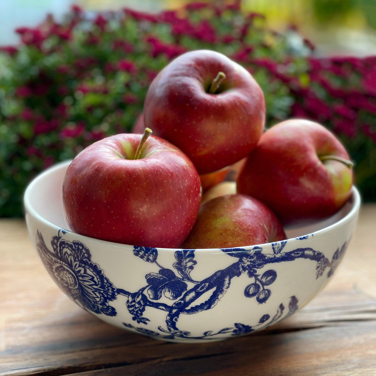 Arcadia Vegetable Serving Bowl by Caskata Artisanal Home on a wooden table.