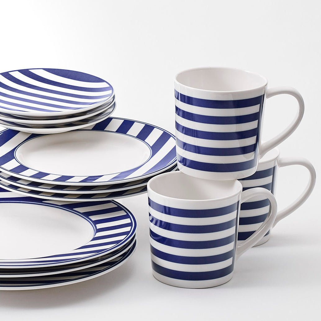 A set of Beach Towel Stripe Salad Plate from Caskata Artisanal Home coastal collection blue and white striped dinnerware.