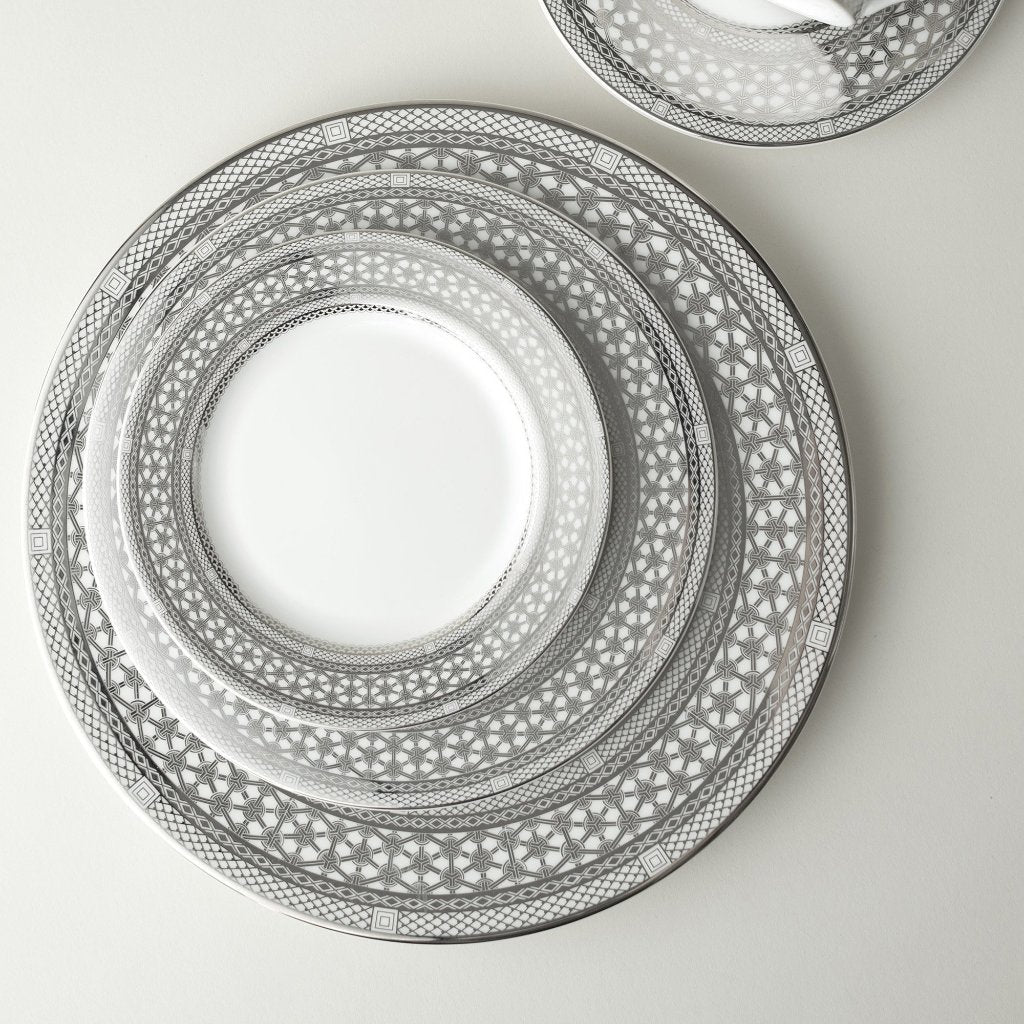 Description: A set of Caskata Artisanal Home Hawthorne Ice Platinum Bread/Butter Plates on a white surface, showcasing elegance and sophistication in every piece.