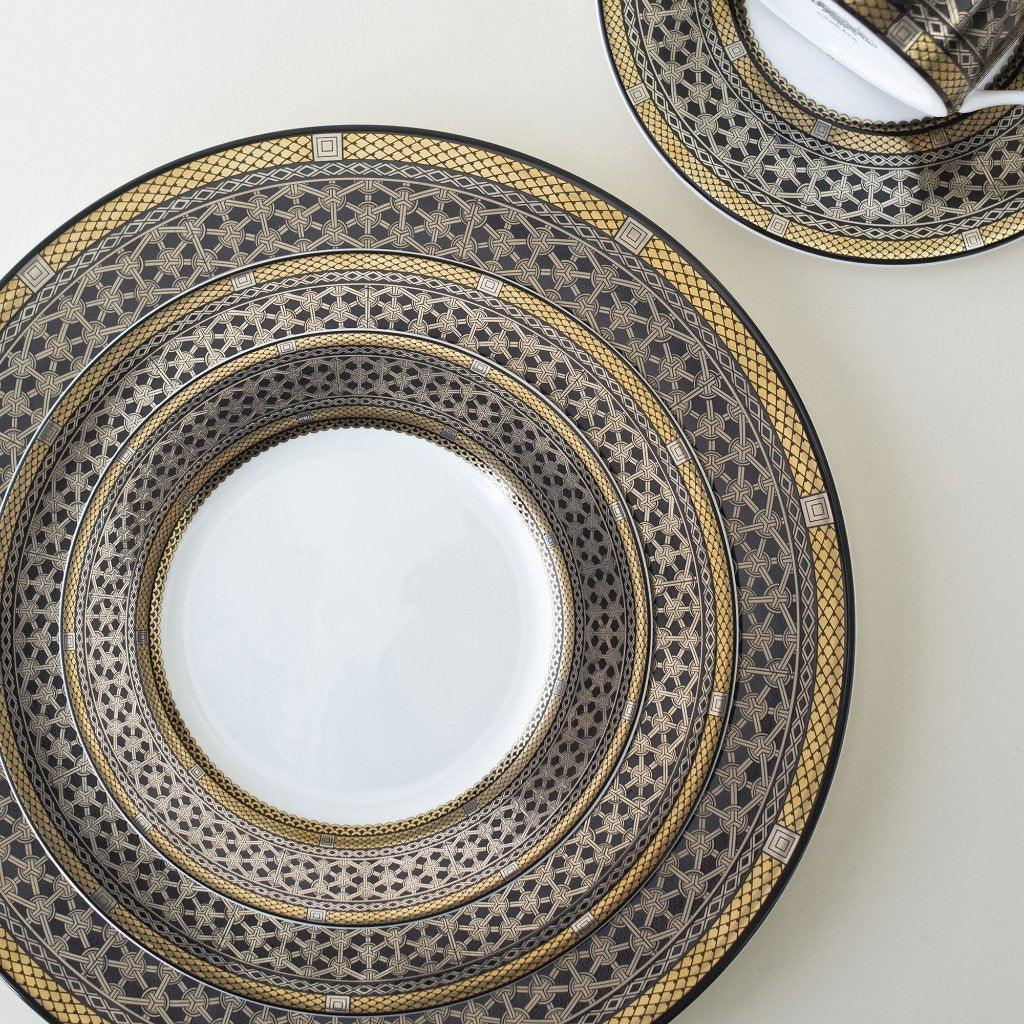 A Hawthorne Onyx Gold &amp; Platinum Salad Plate by Caskata Artisanal Home on a white surface.