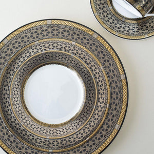 A Hawthorne Onyx Gold & Platinum Salad Plate by Caskata Artisanal Home on a white surface.
