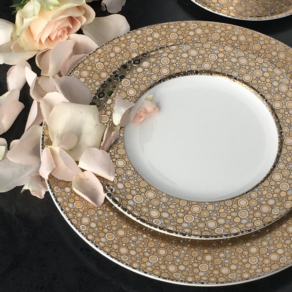 A Ellington Shimmer Gold &amp; Platinum Charger Plate by Caskata Artisanal Home with delicate roses on it.