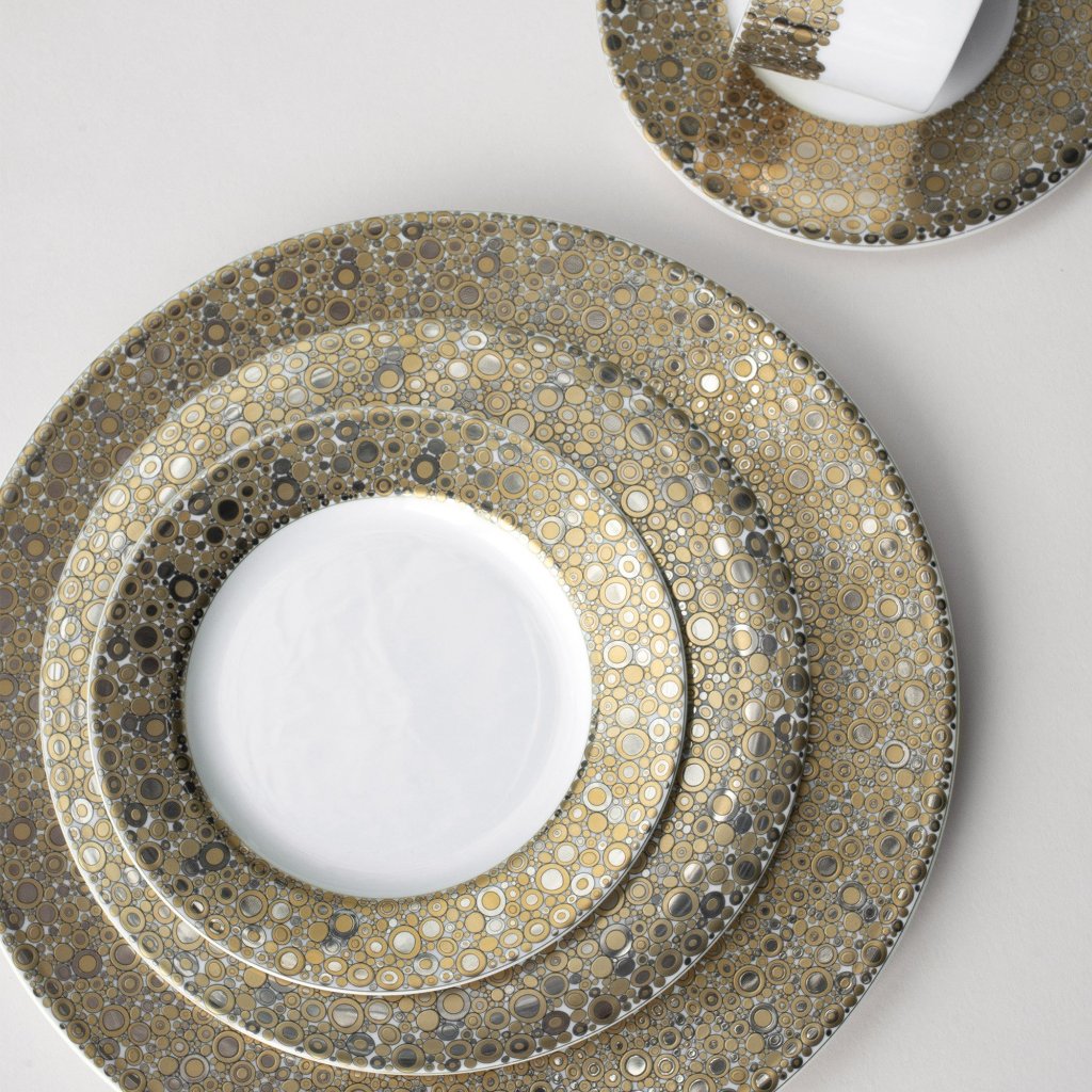 A set of elegant Ellington Shimmer Gold &amp; Platinum Salad Plates by Caskata Artisanal Home on a table radiating the precious metals&#39; luster, creating an exquisite harmony.