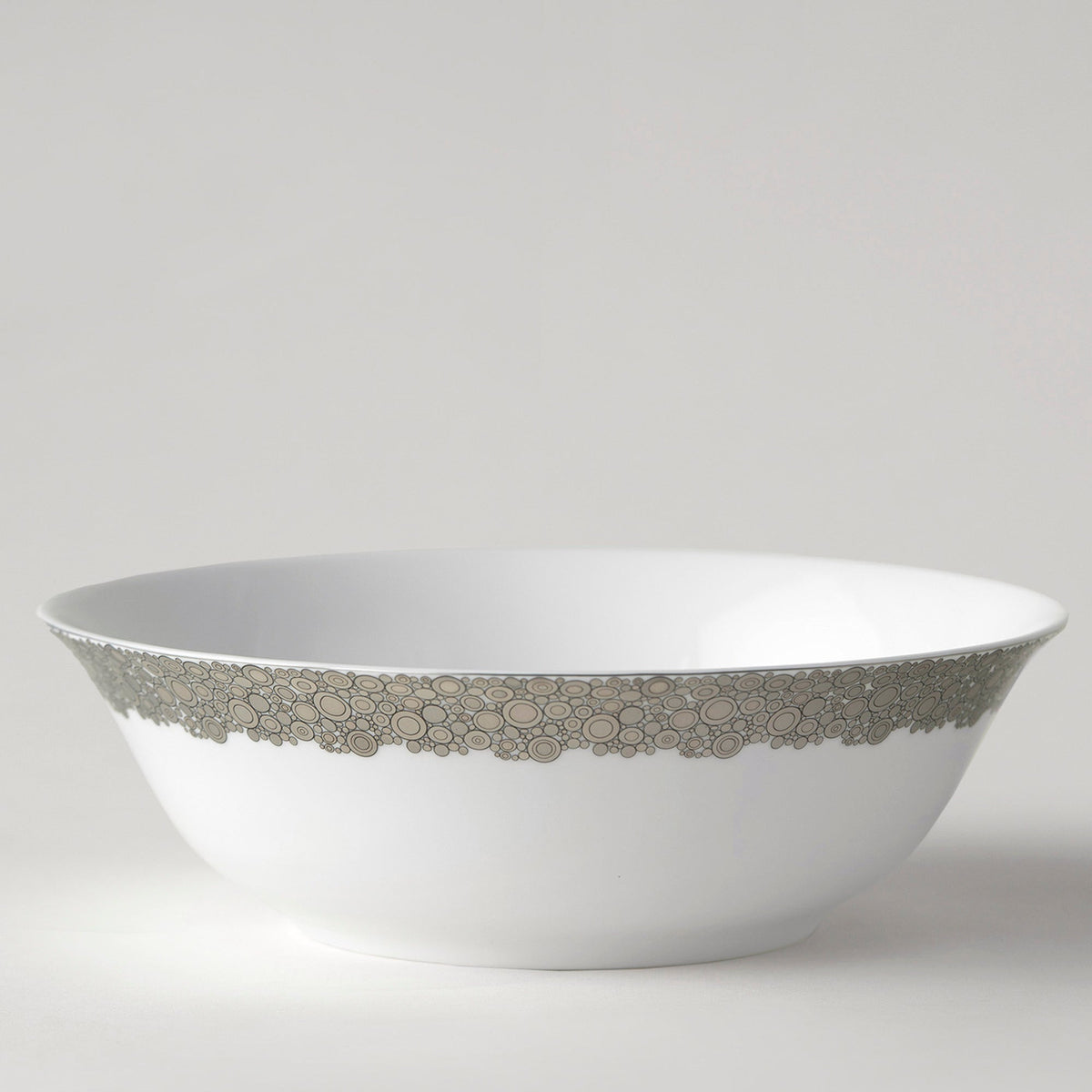 An Ellington Shine Platinum Serving Bowl by Caskata Artisanal Home, with a silver rim that shines.