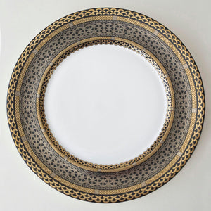 A Hawthorne Onyx Gold & Platinum Charger Plate with a luxurious gold border made by Caskata Artisanal Home.