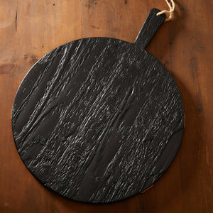 A large-scale profile Black & Natural Round Charcuterie Big Board by Etu Home with stunning wood grain on a wooden table, perfect for holiday entertaining.
