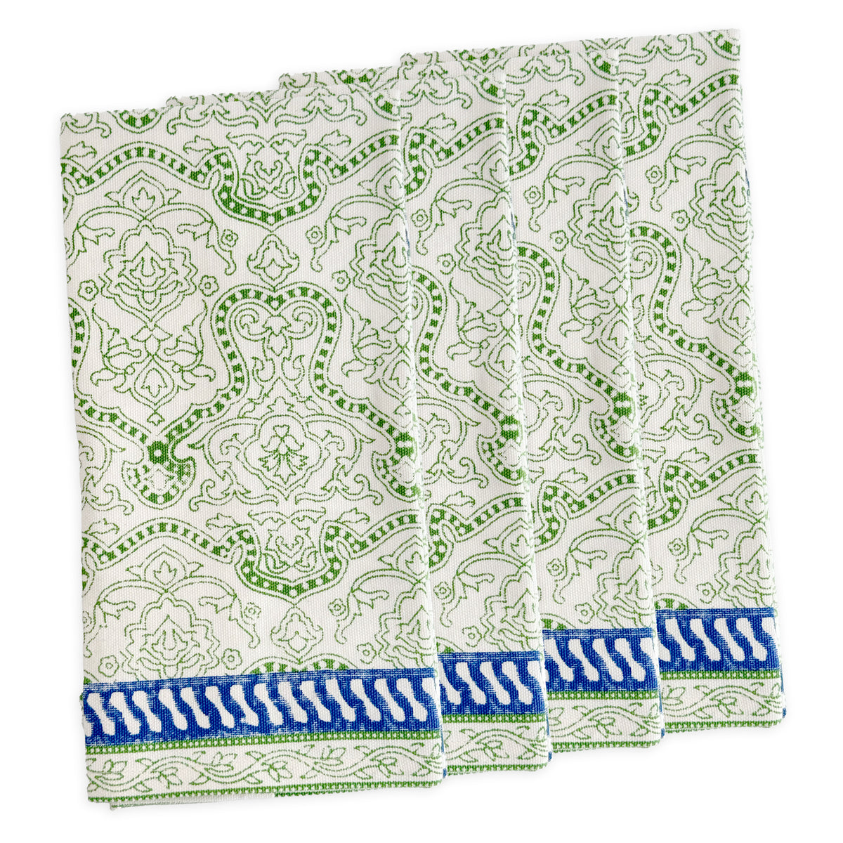 Four folded Block Island Block Print Dinner Napkins by Caskata in white, featuring a green intricate pattern and blue-white border—a charming choice for bohemian table decor.