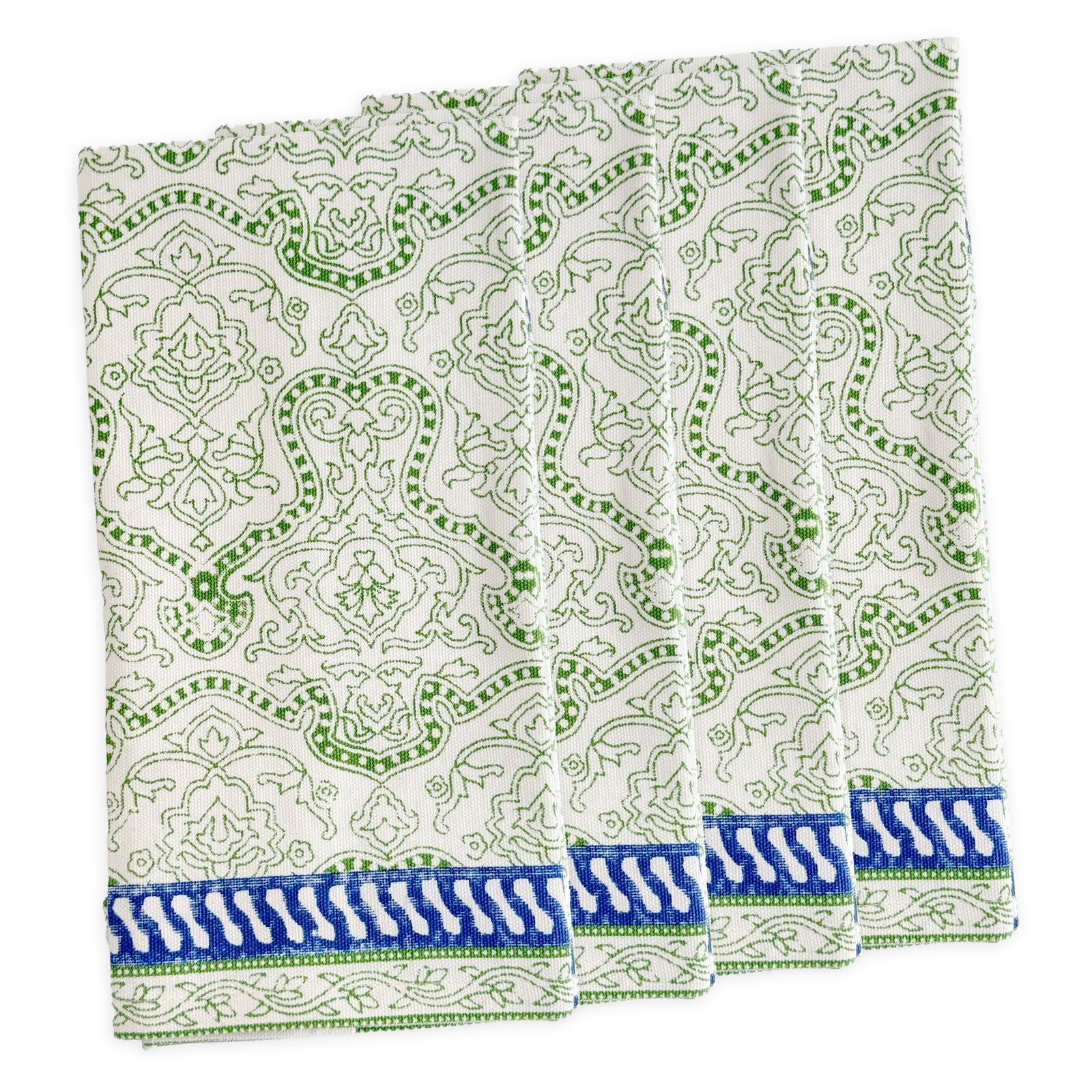 Four folded Block Island Block Print Dinner Napkins by Caskata in white, featuring a green intricate pattern and blue-white border—a charming choice for bohemian table decor.