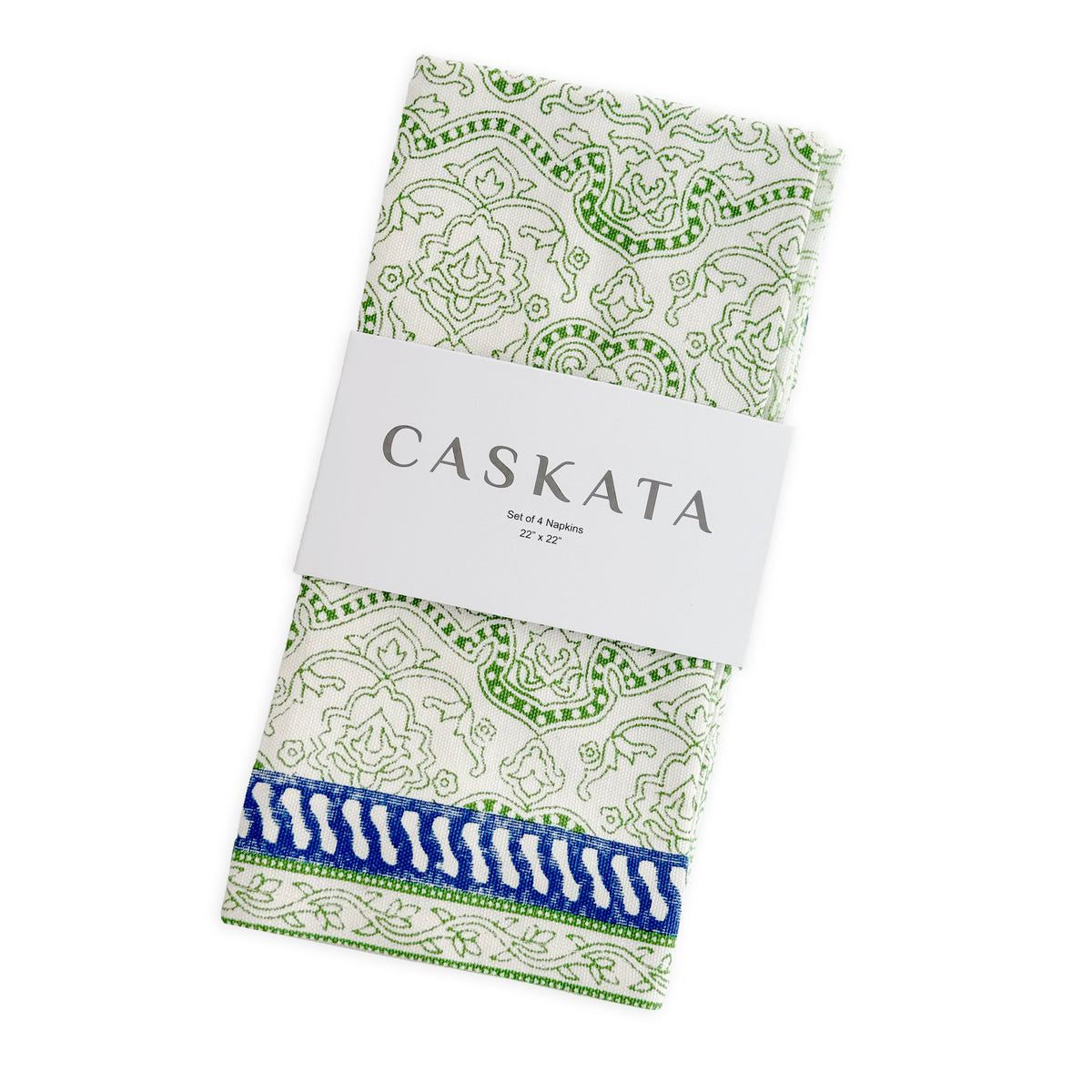 Caskata’s Block Island Block Print Dinner Napkins feature a green and white cotton pattern with a blue border, wrapped in a white "Caskata" label—a perfect boho accent for your table.