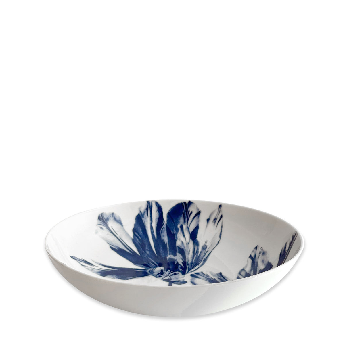 The Caskata Tulip Entrée Bowl features a blue and white porcelain design, bringing elegant charm to any table setting.