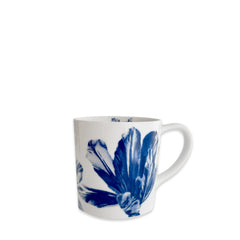 Caskata's Tulip Mug is a white porcelain coffee mug with a handle, featuring a blue botanical design inspired by tulips on its exterior.