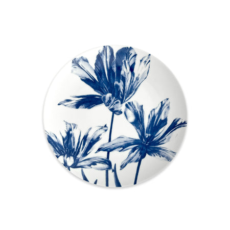 The Caskata Tulip Coupe Salad Plate features an elegant blue floral design with three stylized tulips and stems, beautifully displayed from above on a plain white background.