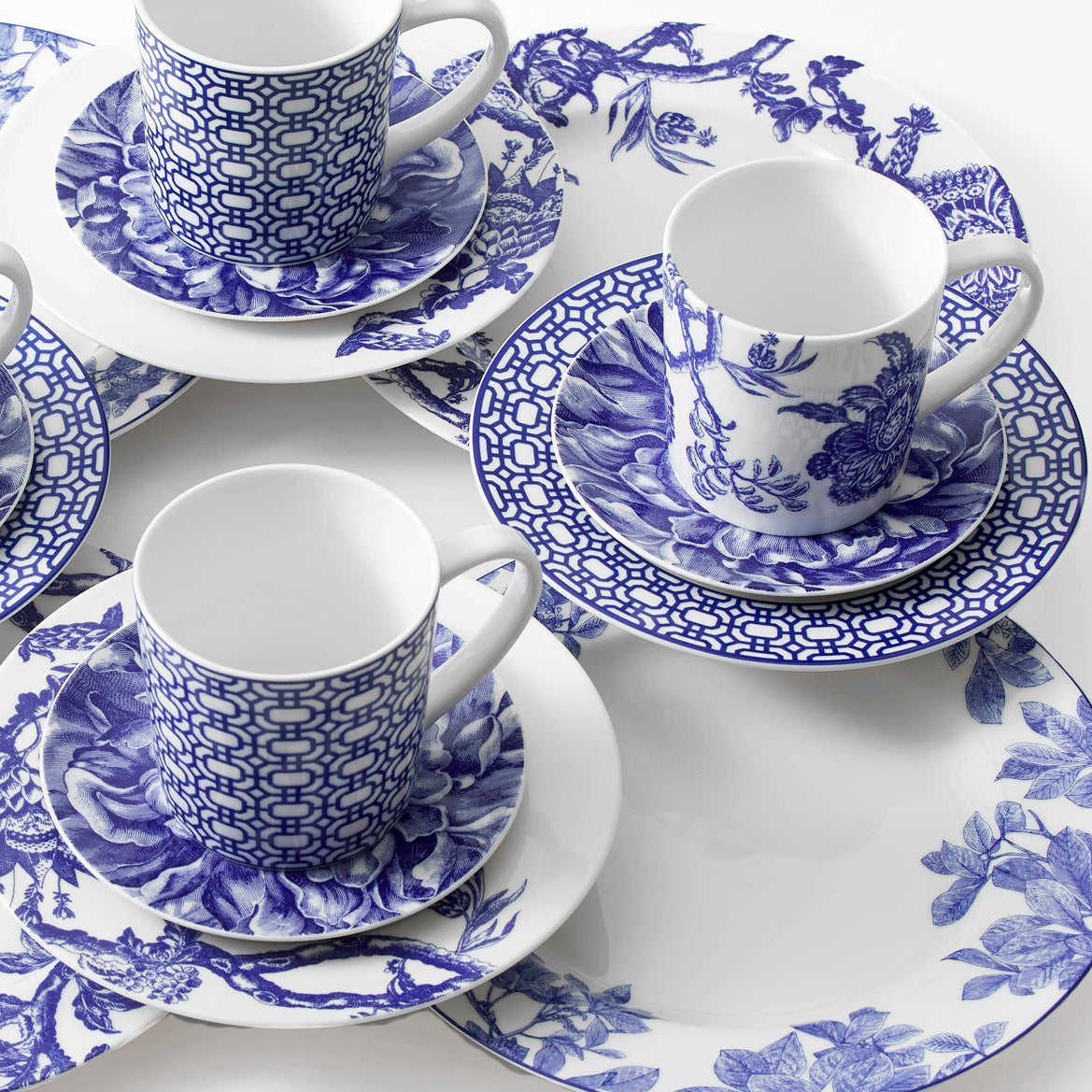 Closeup of mixed botanical romance set of 16 dinnerware pieces in blue and white porcelain from Caskata.