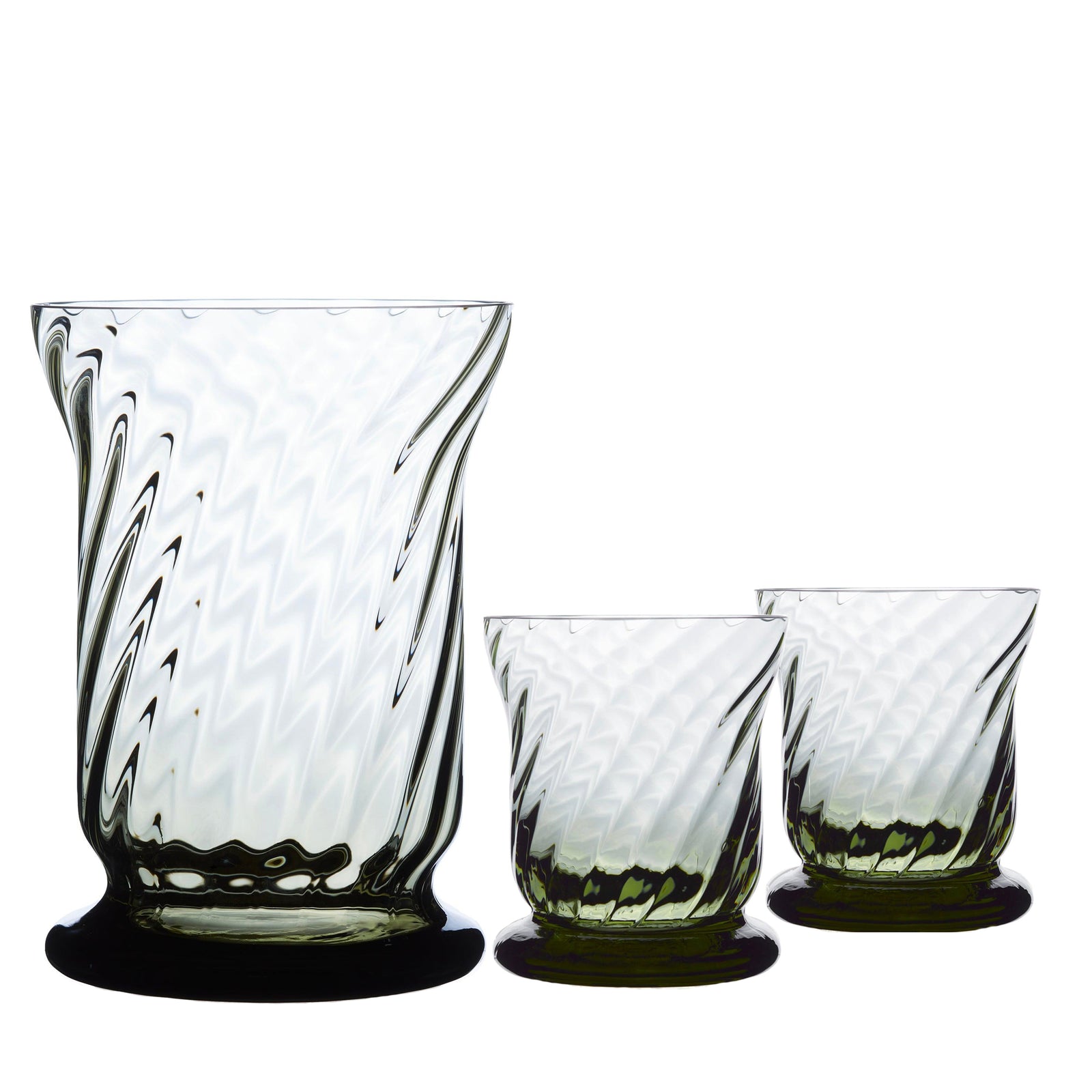 The Quinn Smoke Candlelight Bundle by Caskata, crafted in the Czech Republic, includes three lead-free crystal vases with a swirled design: one large vase on the left and two smaller ones on the right.
