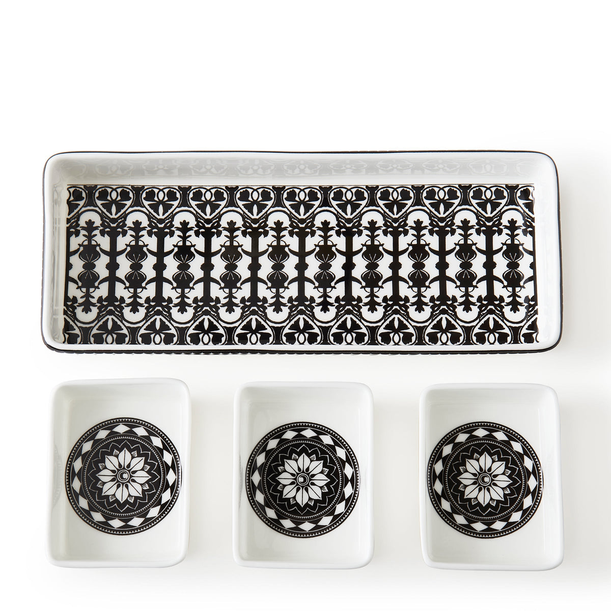 A Casablanca nested tray set by Caskata featuring three bone china bowls, all elegantly displayed in black and white. Perfect for serving a variety of delicious dishes.