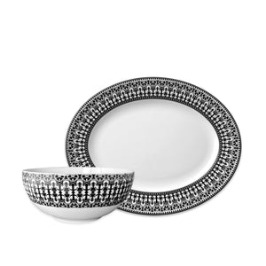 The Caskata Casablanca Serving Set includes a porcelain bowl and oval plate with elegant black scrollwork-inspired borders.