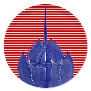 The Caskata Horseshoe Crab Large Round Birchwood Tray features a blue horseshoe crab on a red and white striped circular background, echoing vibrant Finnish design.